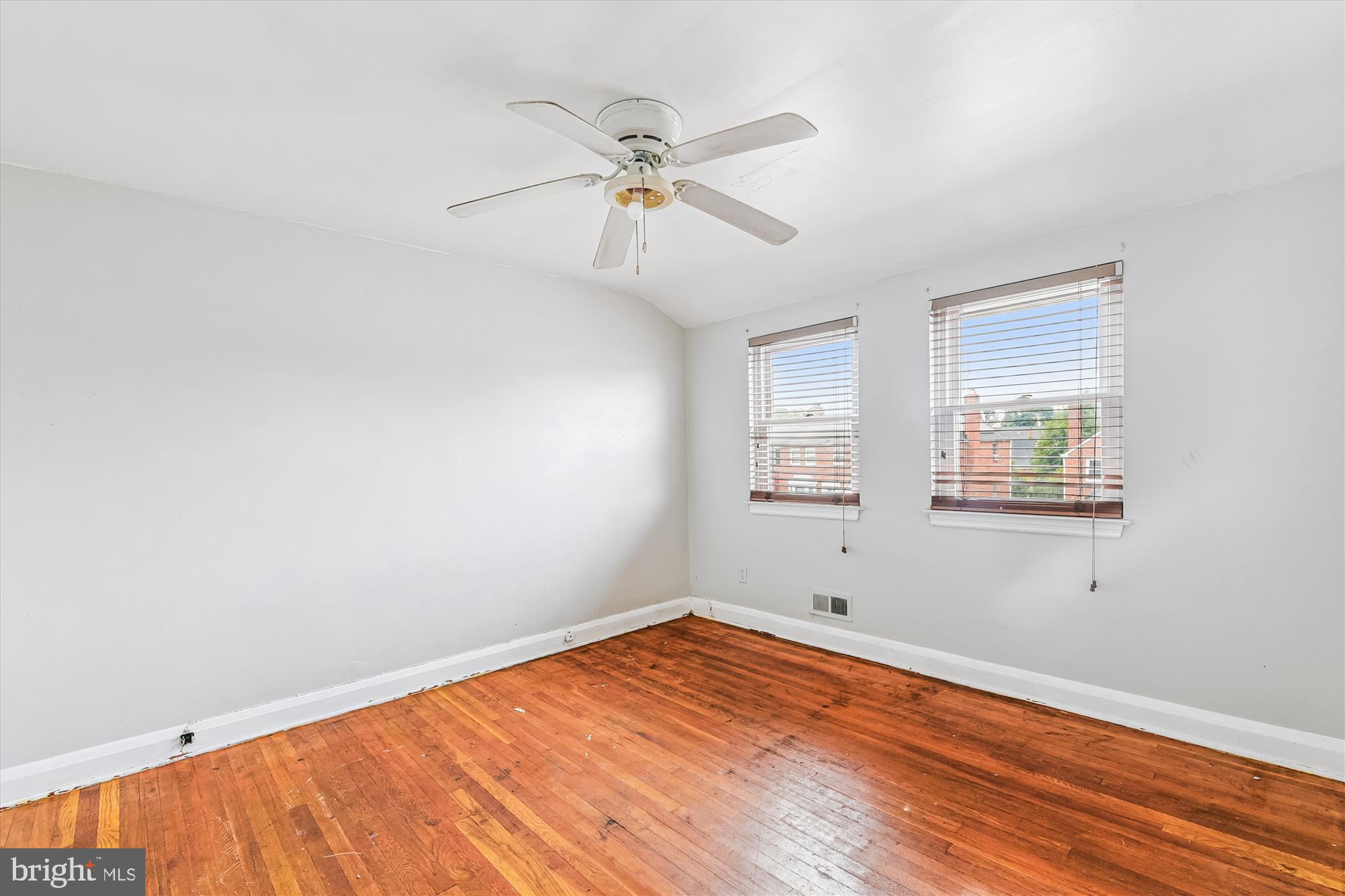 5755 Maplehill Road Baltimore, MD 21239 - Photo 9 of 18 wooden floor in an empty room with a window