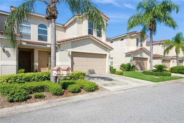 a front view of a house with a yard and a garage