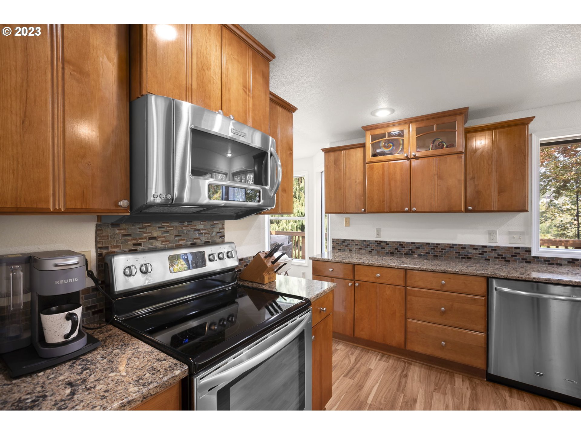 803 Southwest 4th Street Gresham, OR 97080 - Photo 11 of 42 a kitchen with granite countertop a stove and a microwave