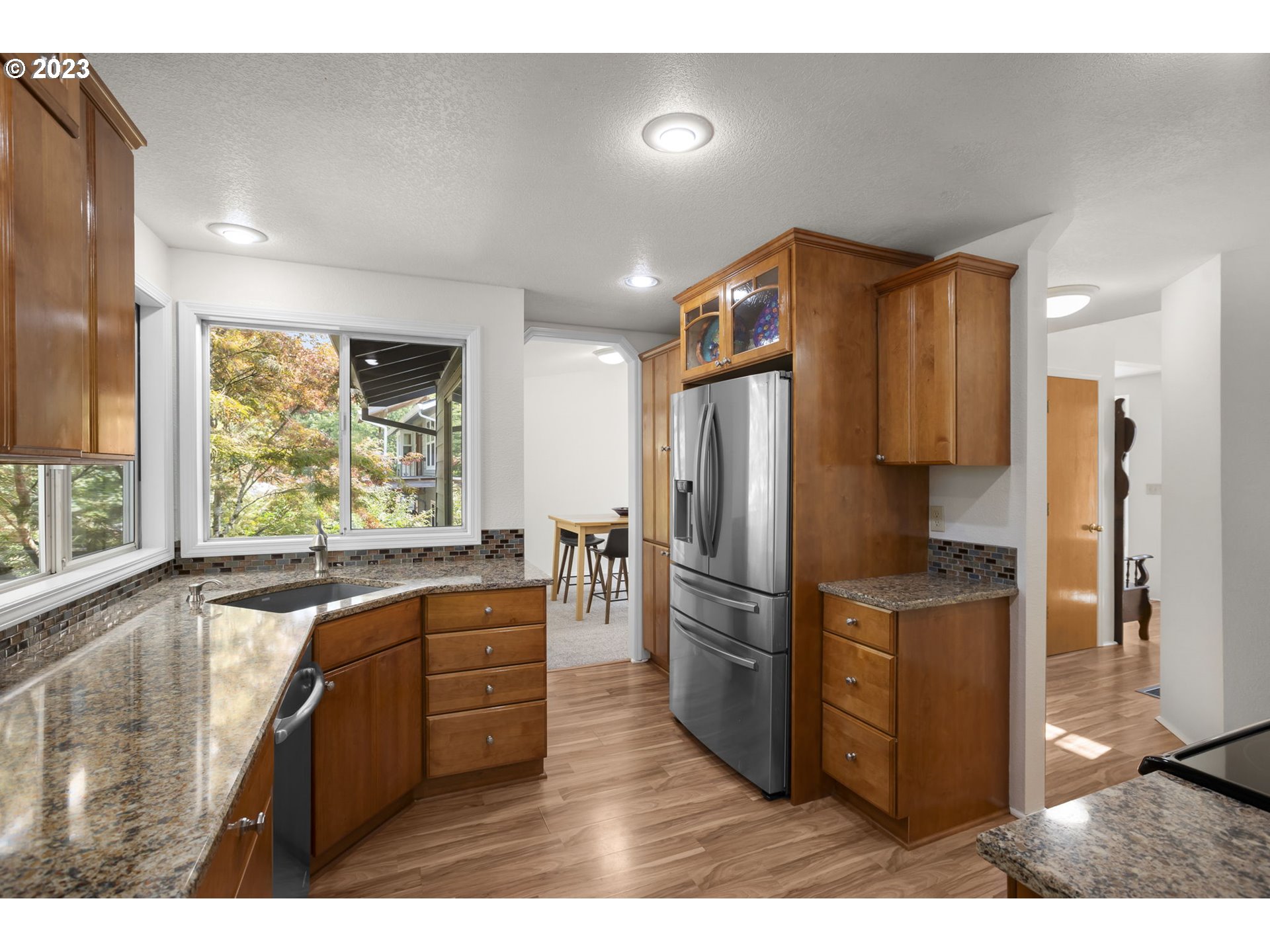 803 Southwest 4th Street Gresham, OR 97080 - Photo 12 of 42 a kitchen with stainless steel appliances granite countertop a refrigerator and a stove