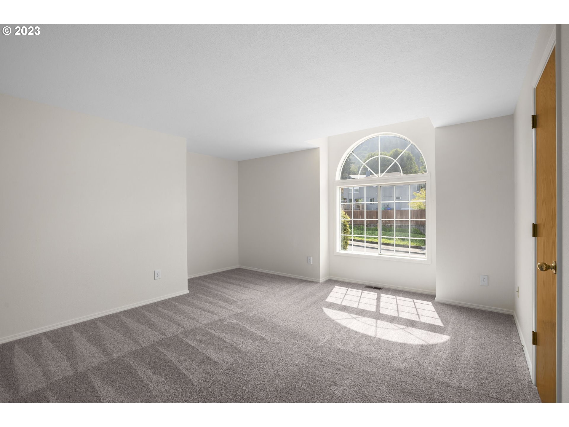 803 Southwest 4th Street Gresham, OR 97080 - Photo 18 of 42 an empty room with wooden floor and windows