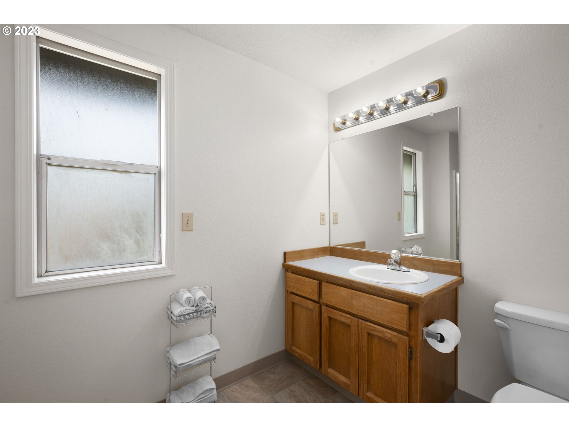 803 Southwest 4th Street Gresham, OR 97080 - Photo 21 of 42 a bathroom with a sink mirror and vanity