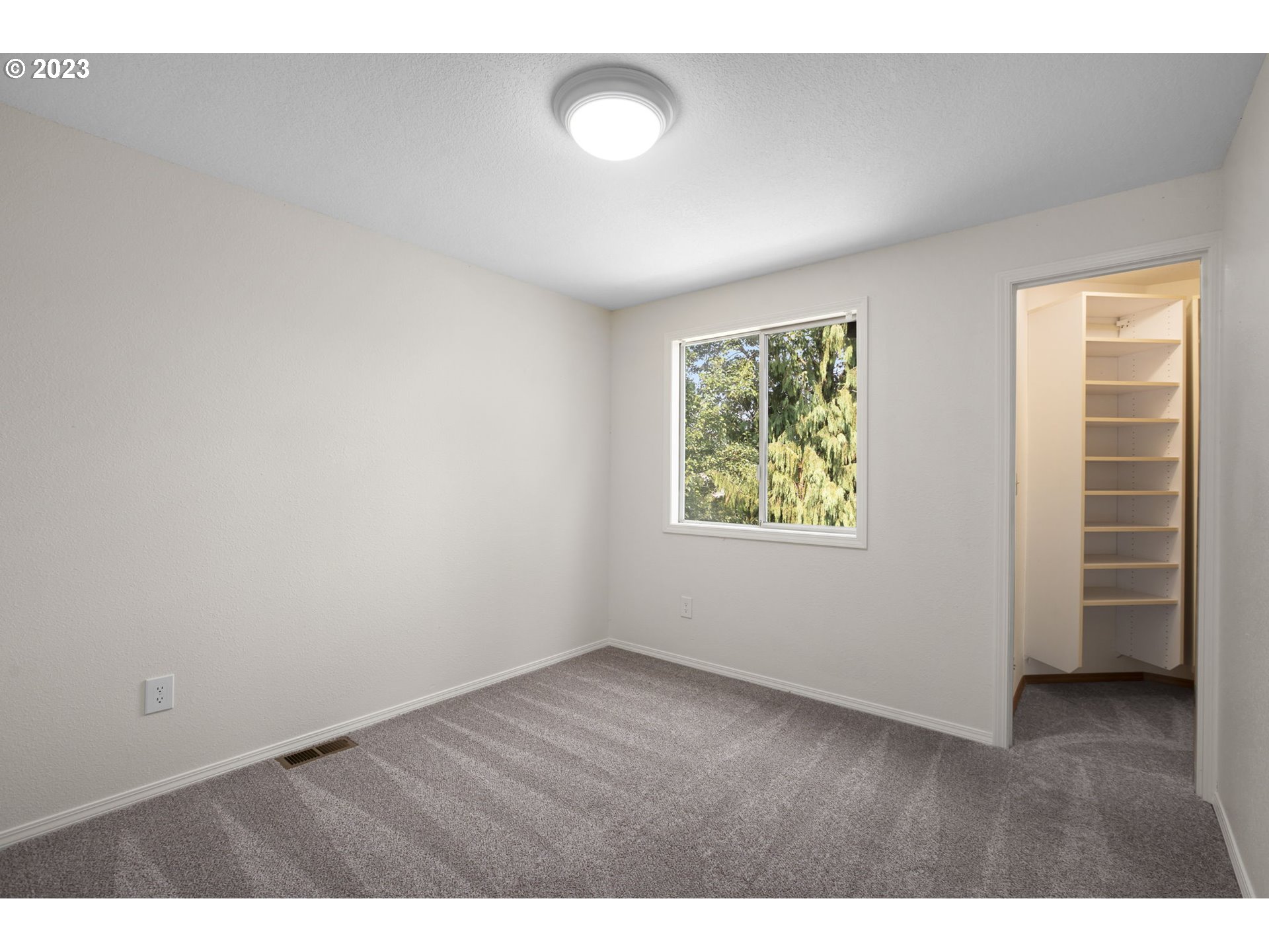 803 Southwest 4th Street Gresham, OR 97080 - Photo 22 of 42 a view of an empty room with a window and wooden floor
