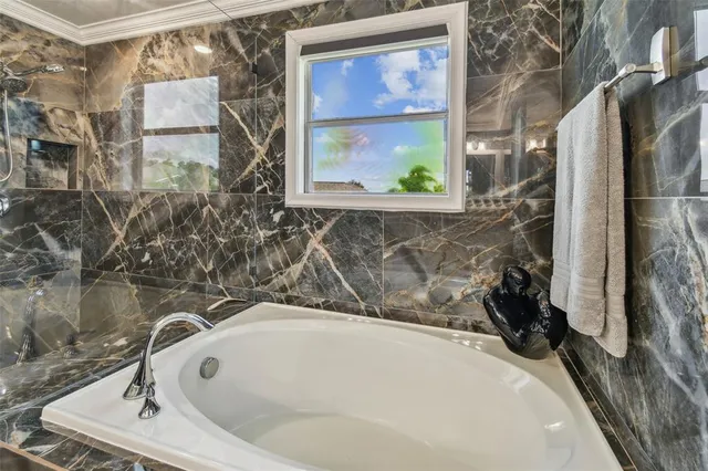 a bathroom with a granite countertop shower a mirror and a sink