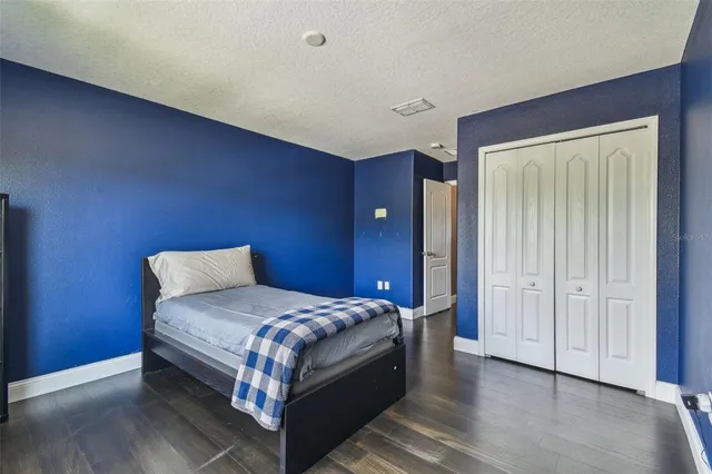 a bedroom with a bed and a dresser