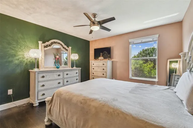 a bedroom with a bed and a car parked