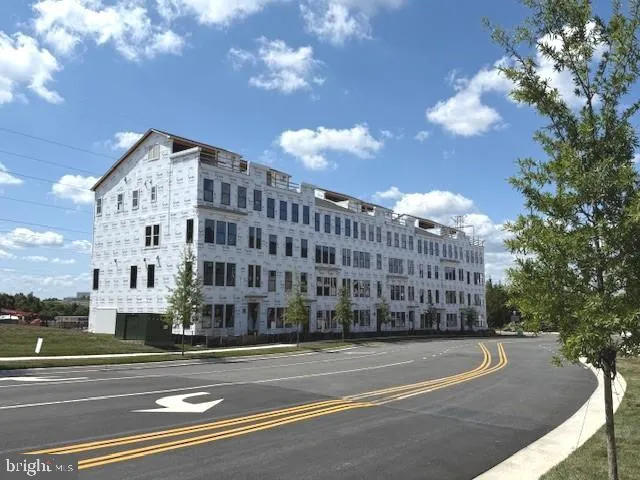 a view of a tall building next to a road