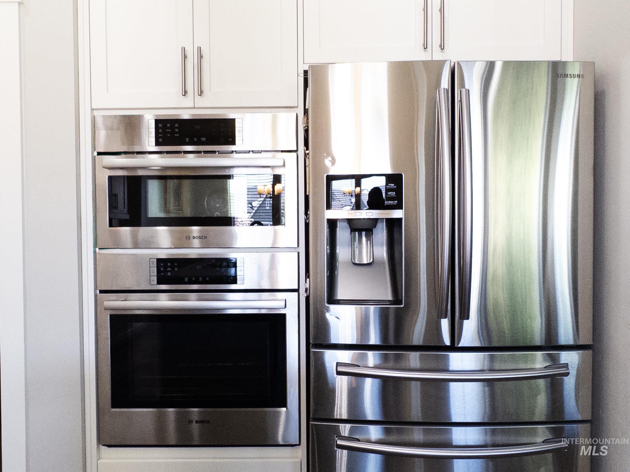 4577 North Comiso Place Meridian, ID 83646 - Photo 13 of 47 Kitchen featuring appliances with stainless steel finishes and white cabinets
