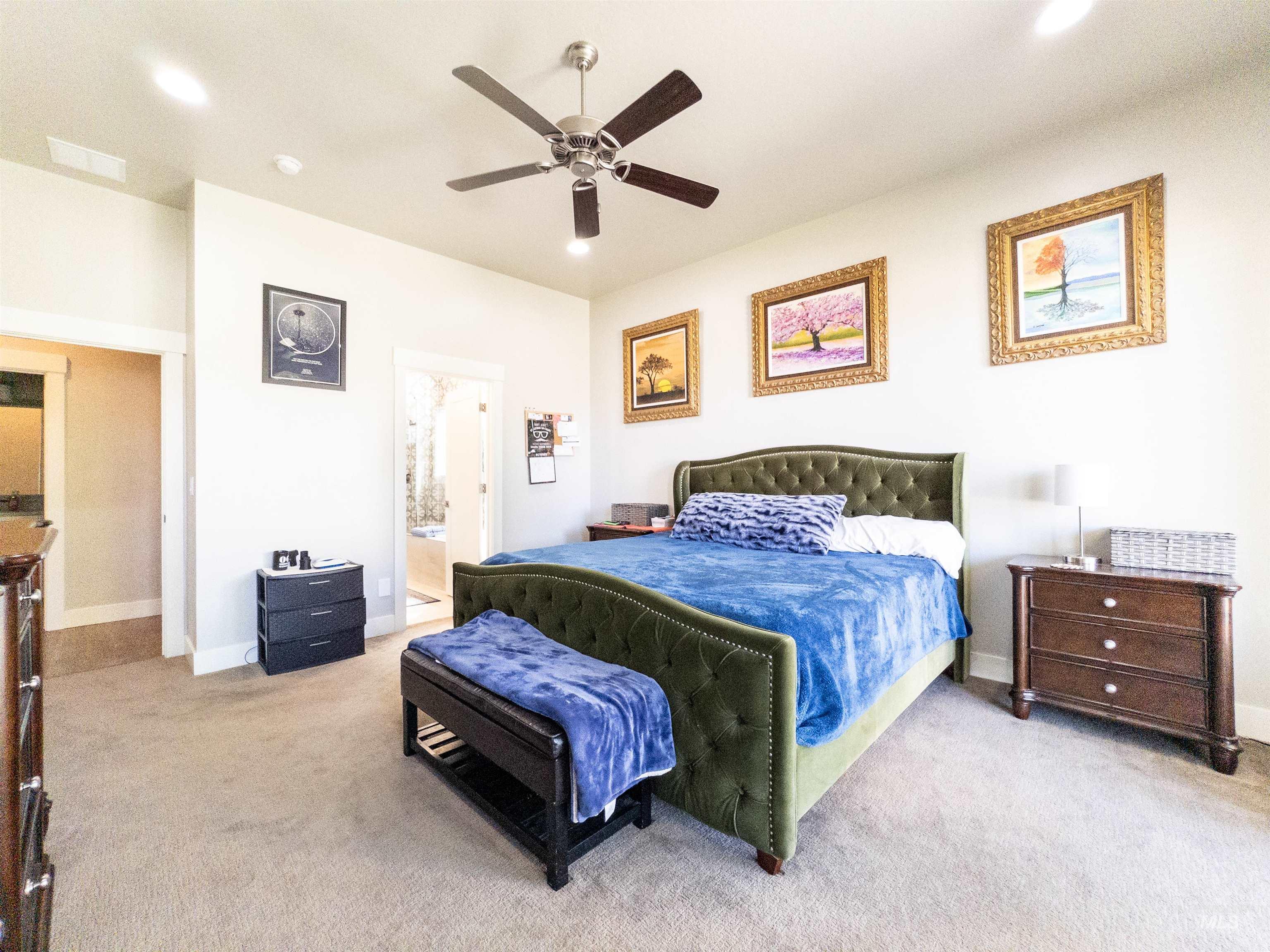 4577 North Comiso Place Meridian, ID 83646 - Photo 22 of 47 Bedroom featuring light carpet, a ceiling fan, recessed lighting, and ensuite bathroom