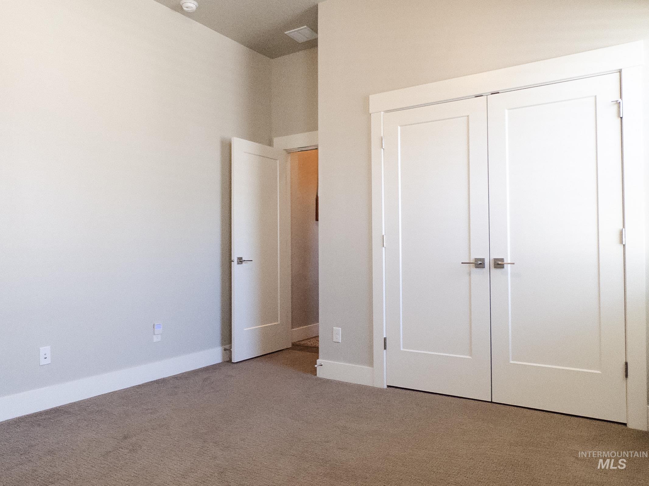 4577 North Comiso Place Meridian, ID 83646 - Photo 34 of 47 Unfurnished bedroom featuring a closet and carpet