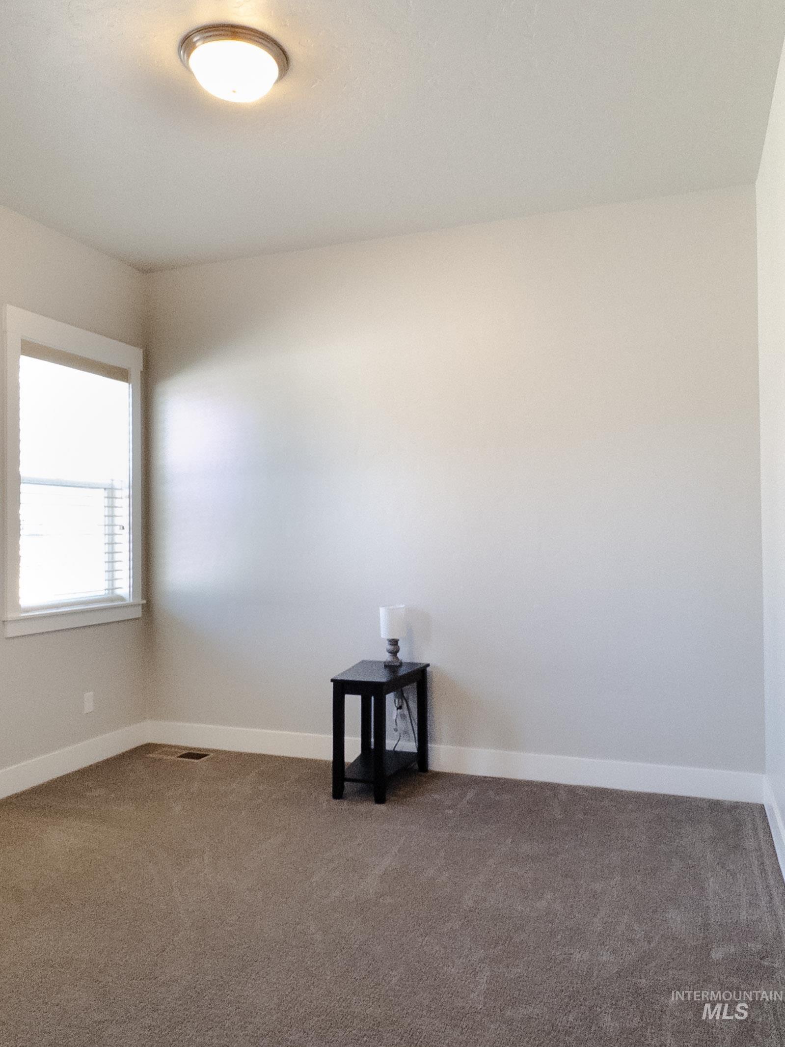 4577 North Comiso Place Meridian, ID 83646 - Photo 35 of 47 Carpeted empty room featuring baseboards