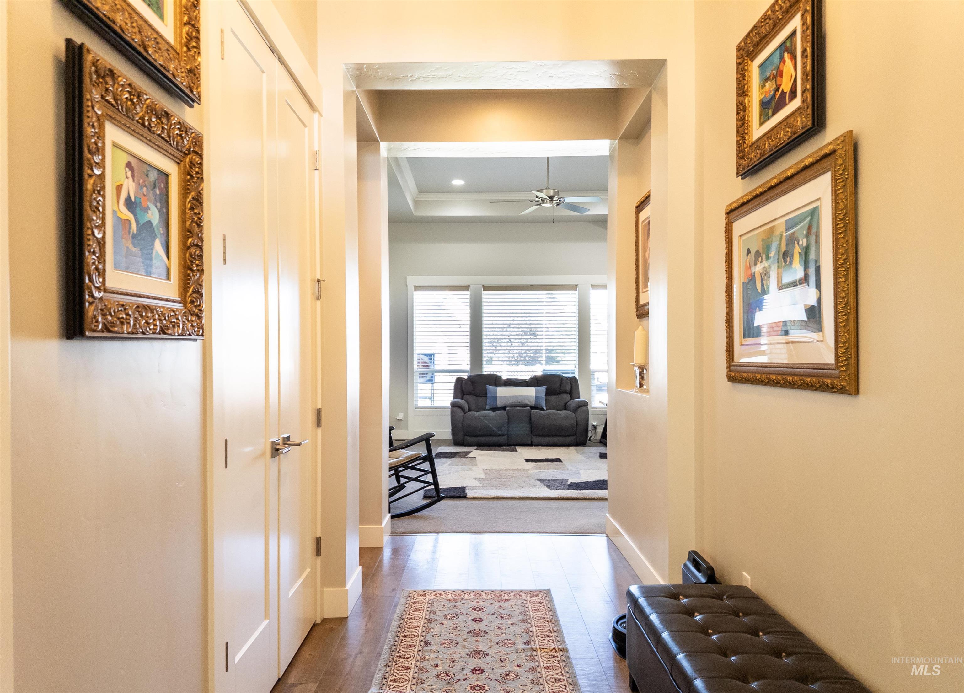 4577 North Comiso Place Meridian, ID 83646 - Photo 4 of 47 Hallway with dark wood-style flooring and a tray ceiling