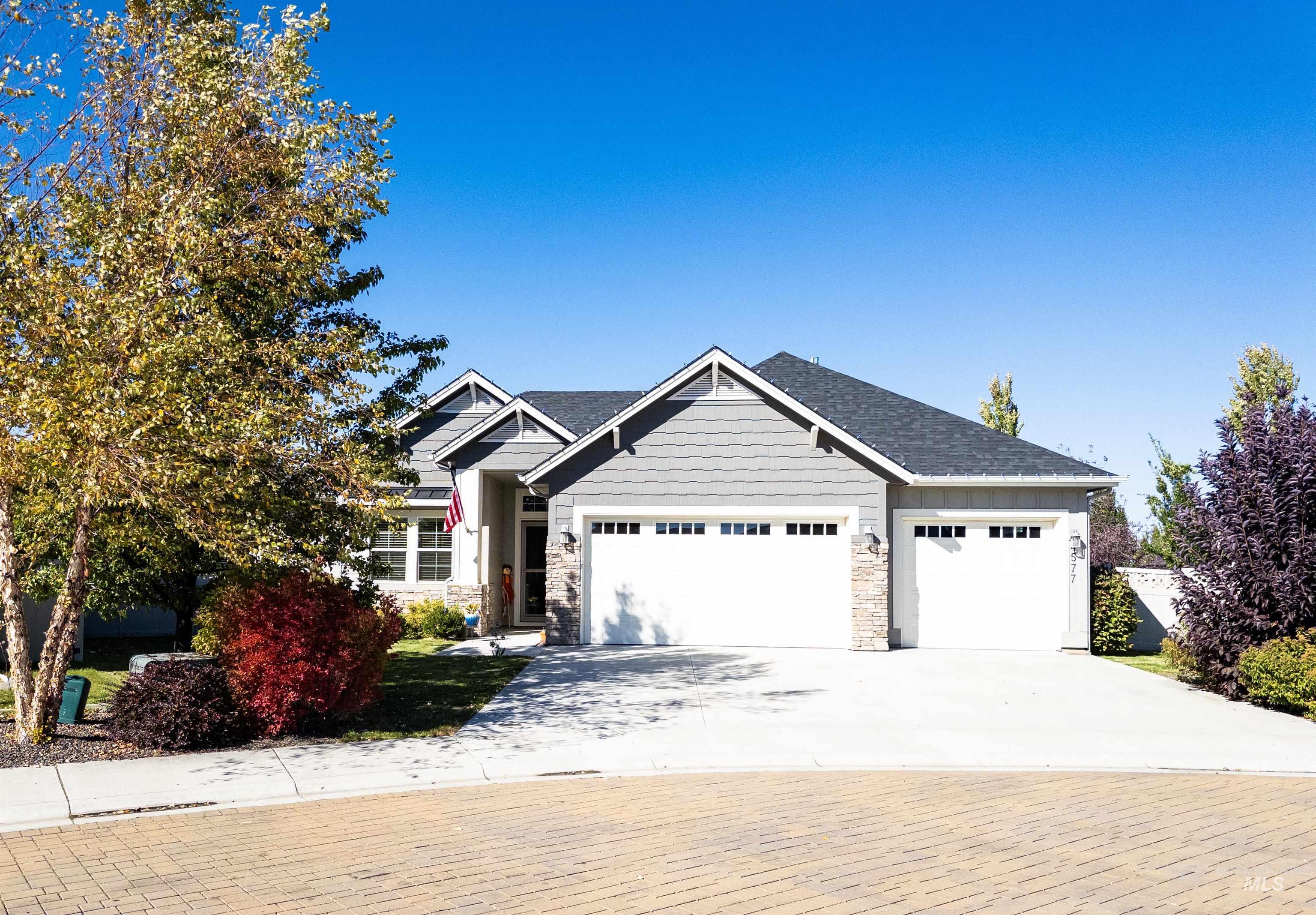 4577 North Comiso Place Meridian, ID 83646 - Photo 45 of 47 Craftsman house with concrete driveway, stone siding, and a garage
