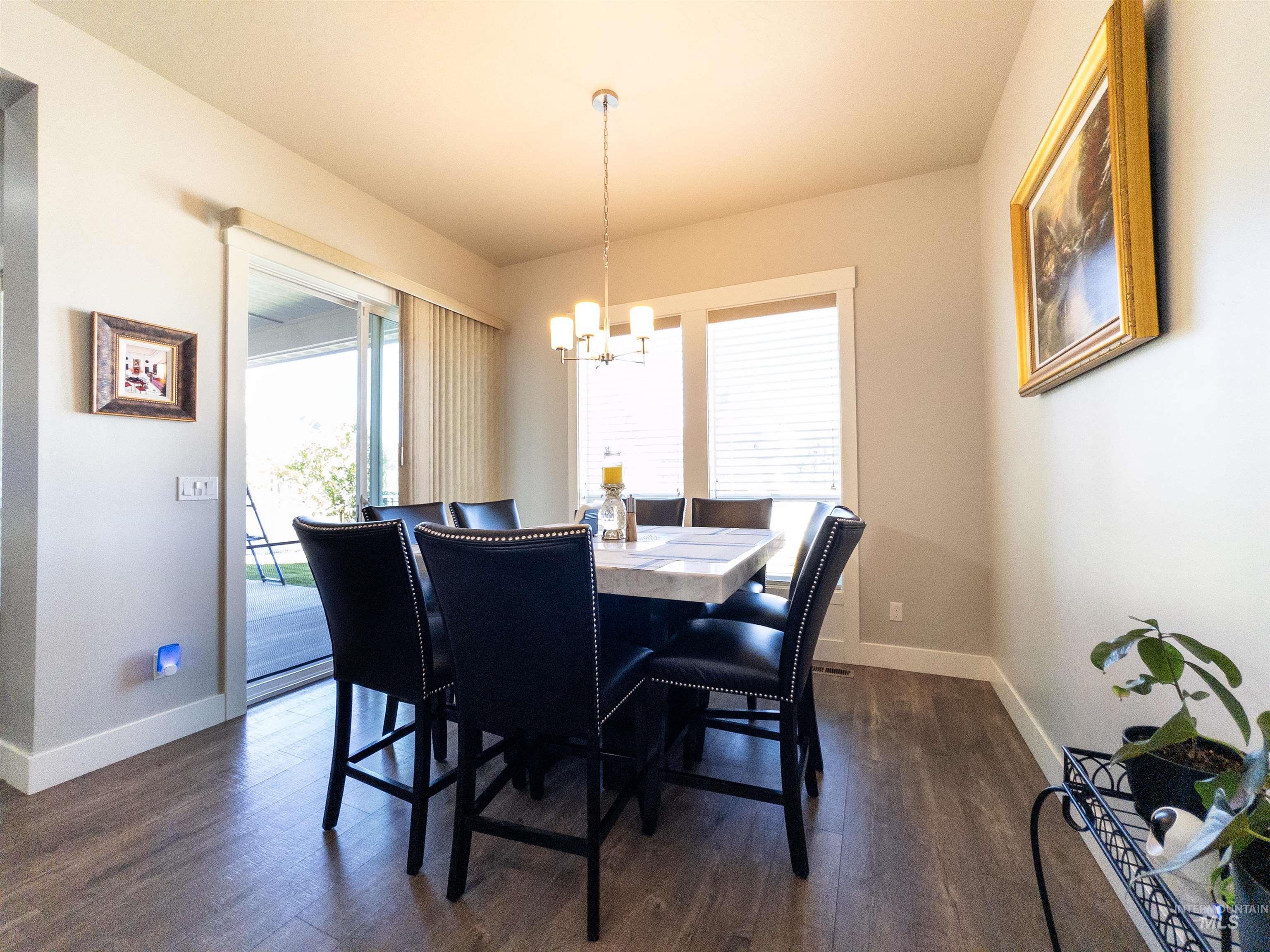 4577 North Comiso Place Meridian, ID 83646 - Photo 9 of 47 Dining room with dark wood-type flooring and a chandelier