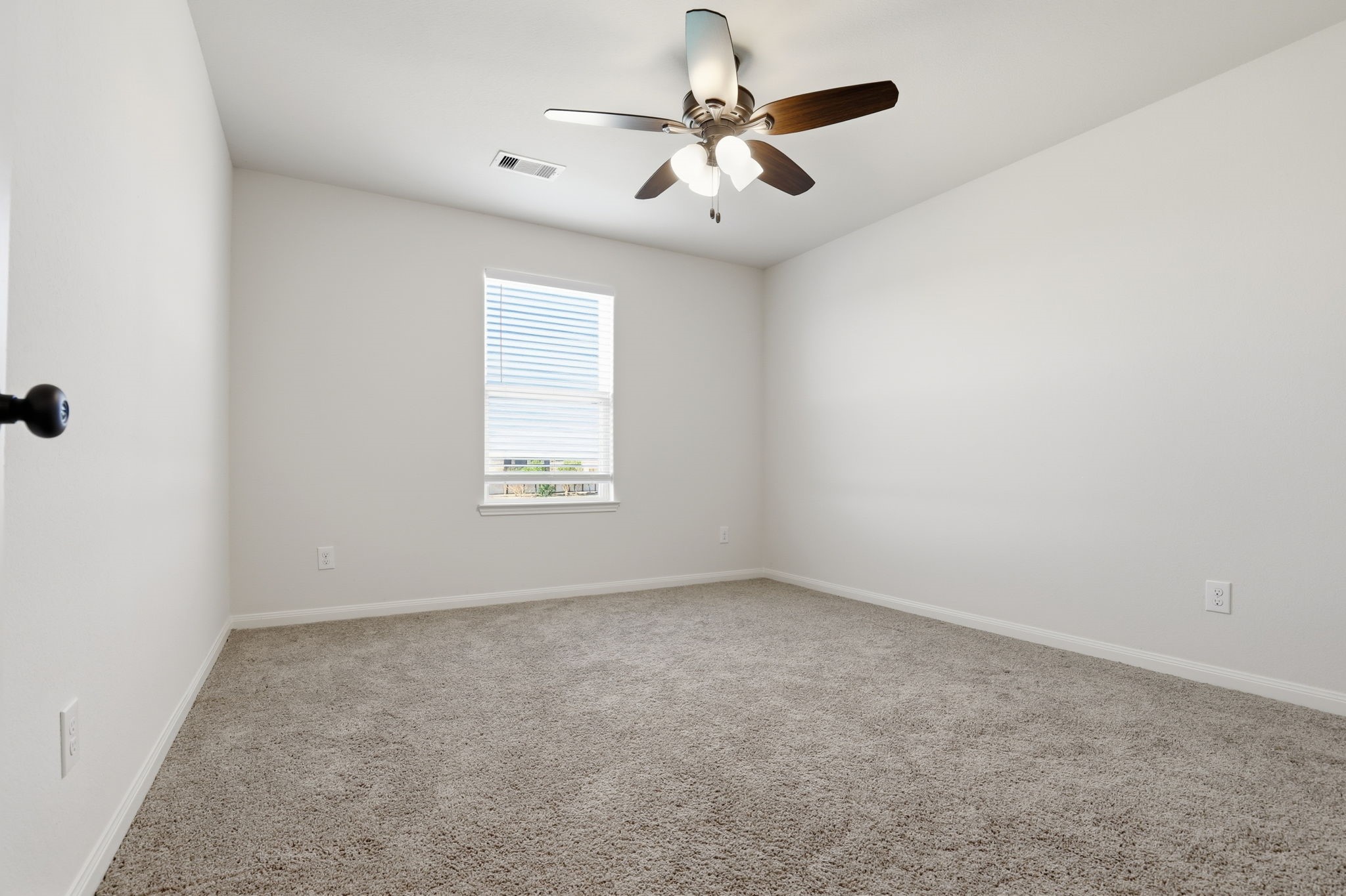2044 Mule Ridge Drive Katy, TX 77493 - Photo 21 of 24 an empty room with windows and fan
