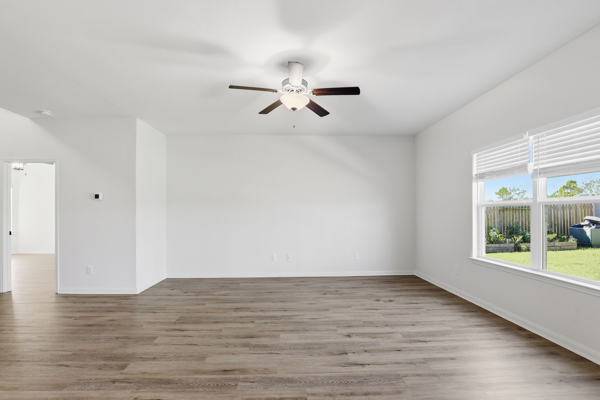 2044 Mule Ridge Drive Katy, TX 77493 - Photo 4 of 24 wooden floor in an empty room with a window