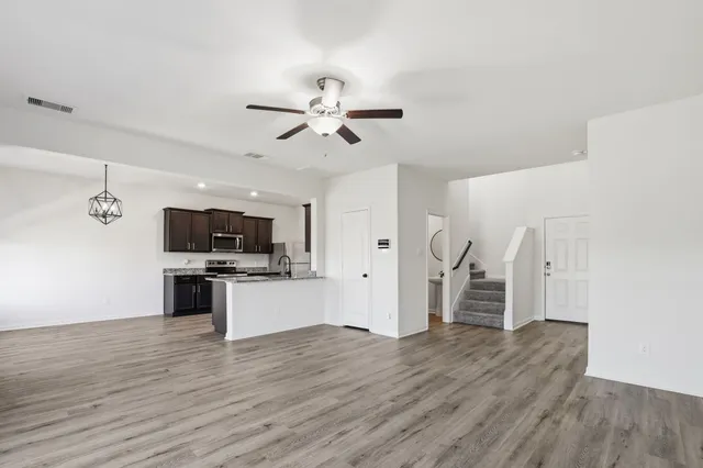 a view of kitchen with sink microwave refrigerator and stove