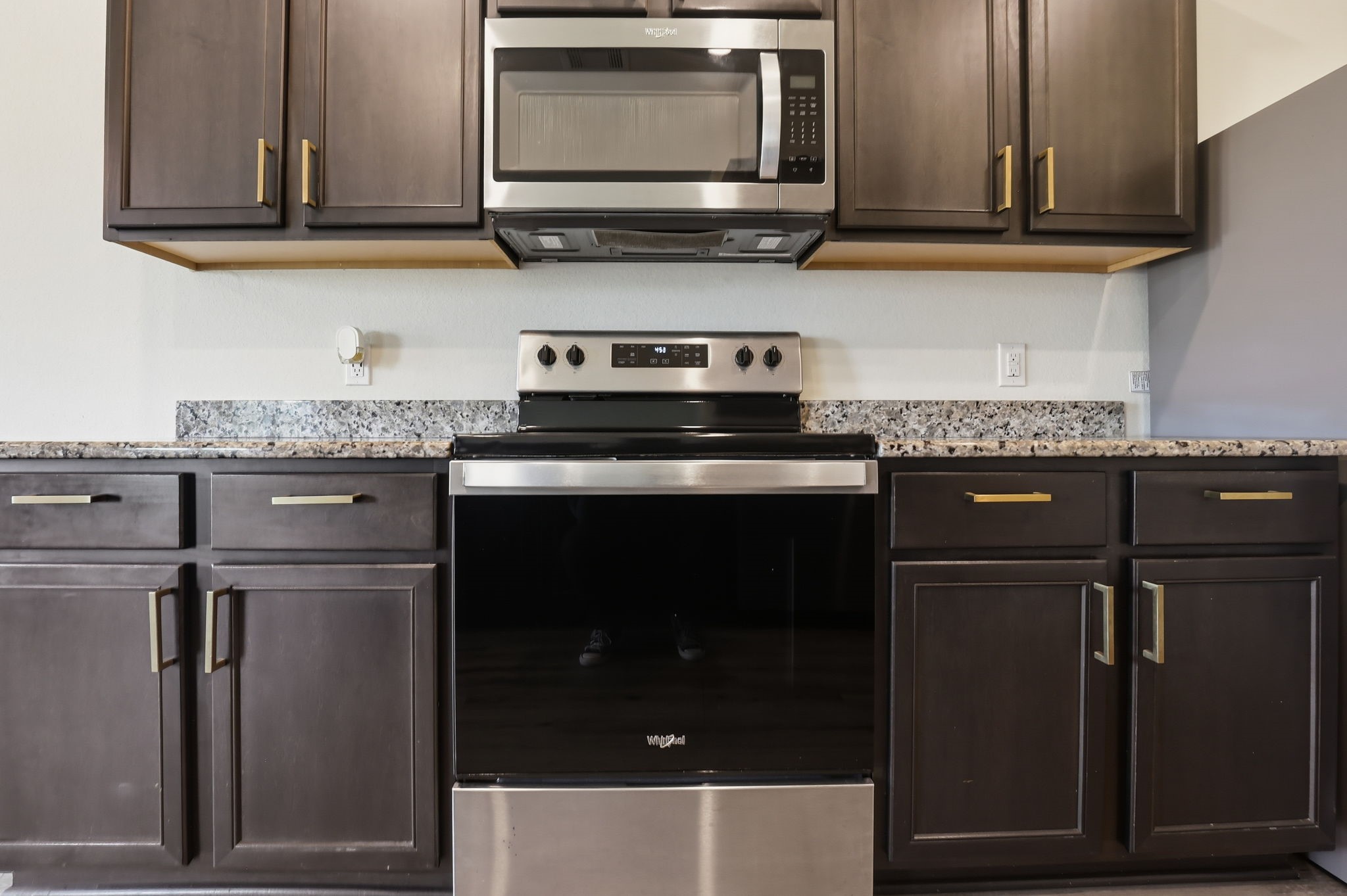 2044 Mule Ridge Drive Katy, TX 77493 - Photo 7 of 24 a kitchen with stainless steel appliances granite countertop a stove and a microwave
