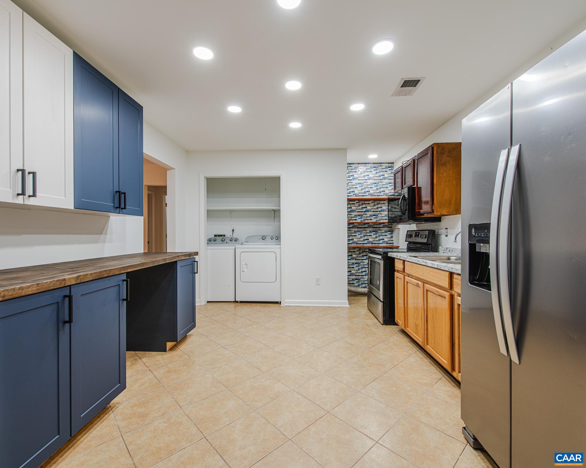 3189 James River Road Esmont, VA 22937 - Photo 6 of 28 a kitchen with stainless steel appliances granite countertop a refrigerator sink and cabinets