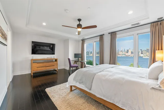 a bedroom with a bed and glass walk in closet