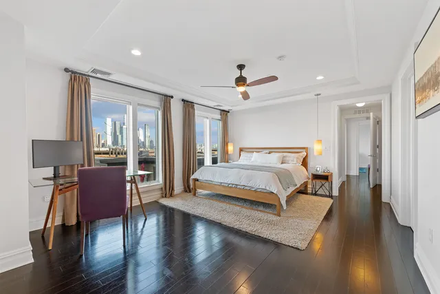 a spacious bedroom with a bed and wooden floor