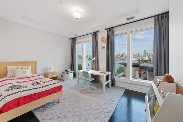 a very nice looking room with a large window and a bed