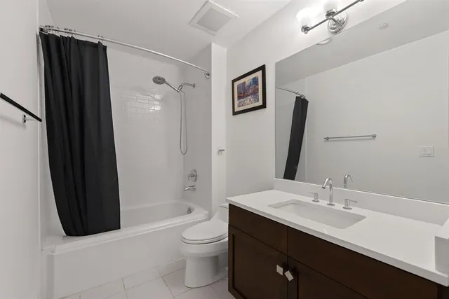 a bathroom with a sink a toilet a shower a mirror and shower