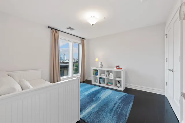 a living room with a baby crib furniture and a window