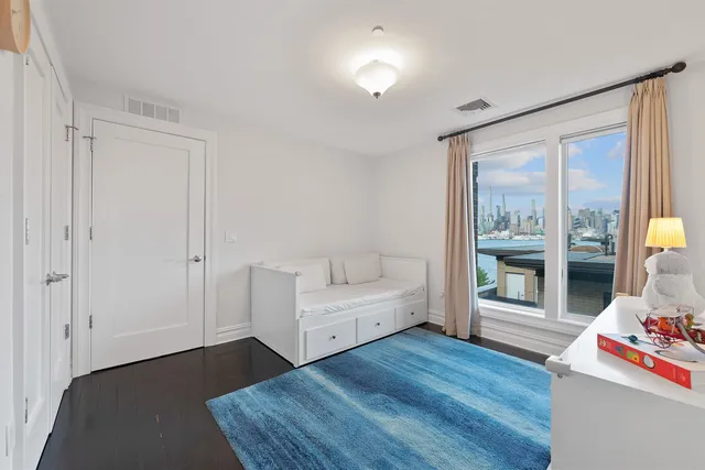 a bedroom with furniture and wooden floor