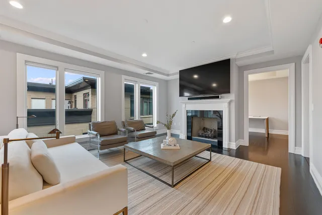 a living room with furniture a flat screen tv and a fireplace