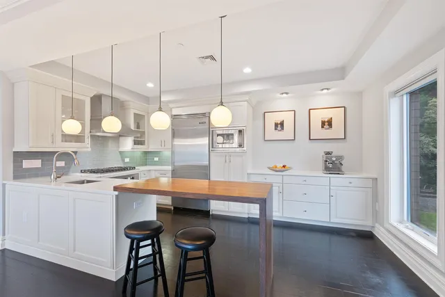 a large kitchen with lots of counter space cabinets and appliances