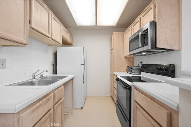 a kitchen with stainless steel appliances granite countertop a sink and a stove