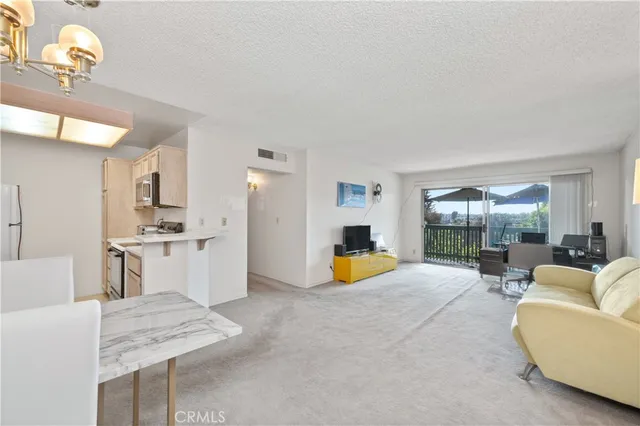 a view of kitchen with dining table and chairs