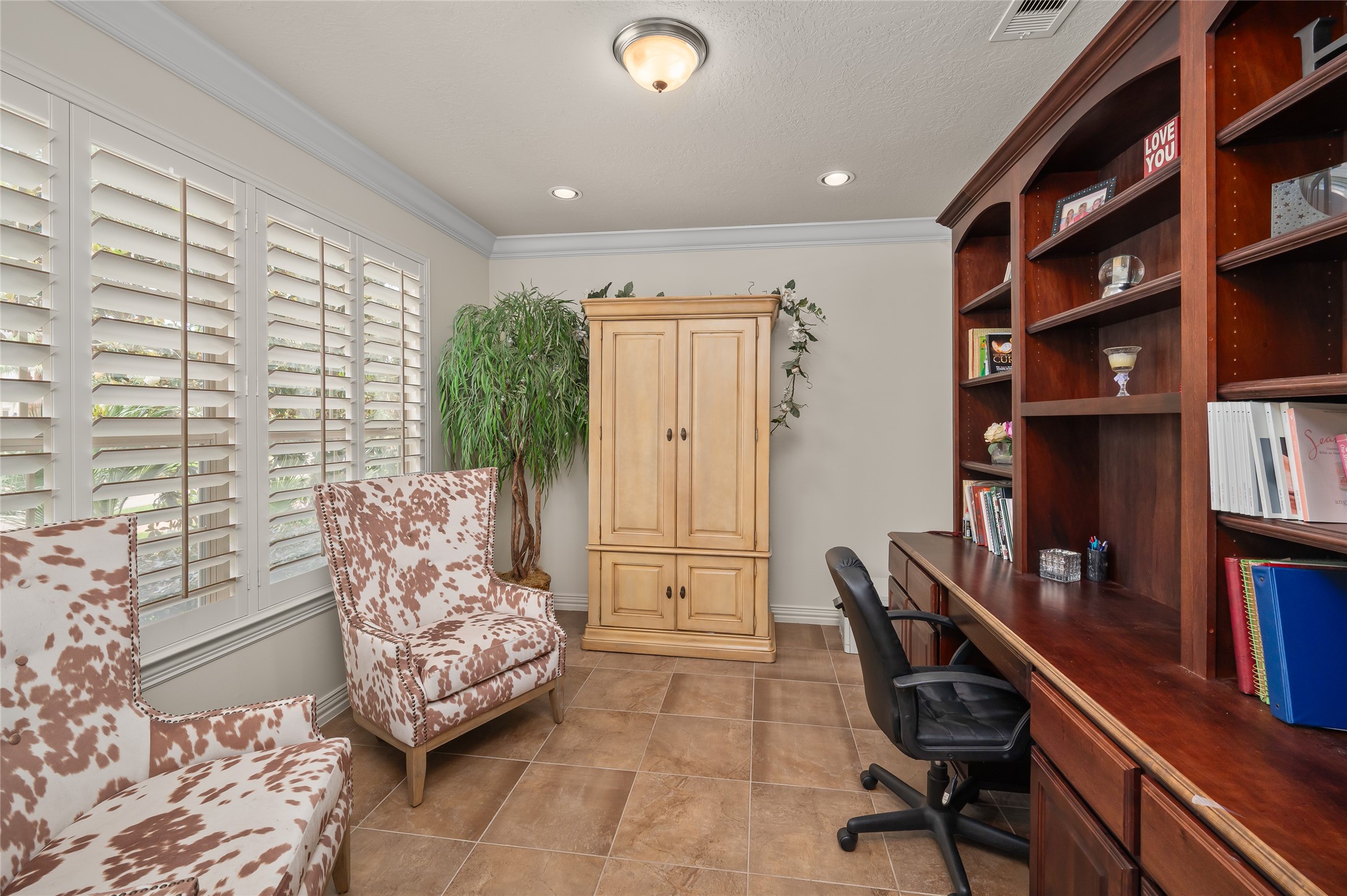 2127 Thicket Ridge Lane Houston, TX 77077 - Photo 8 of 48 The large office/library features a built in desk with accompanying cabinetry and bookcases. The plantation shutters open this room to the stunning front yard.