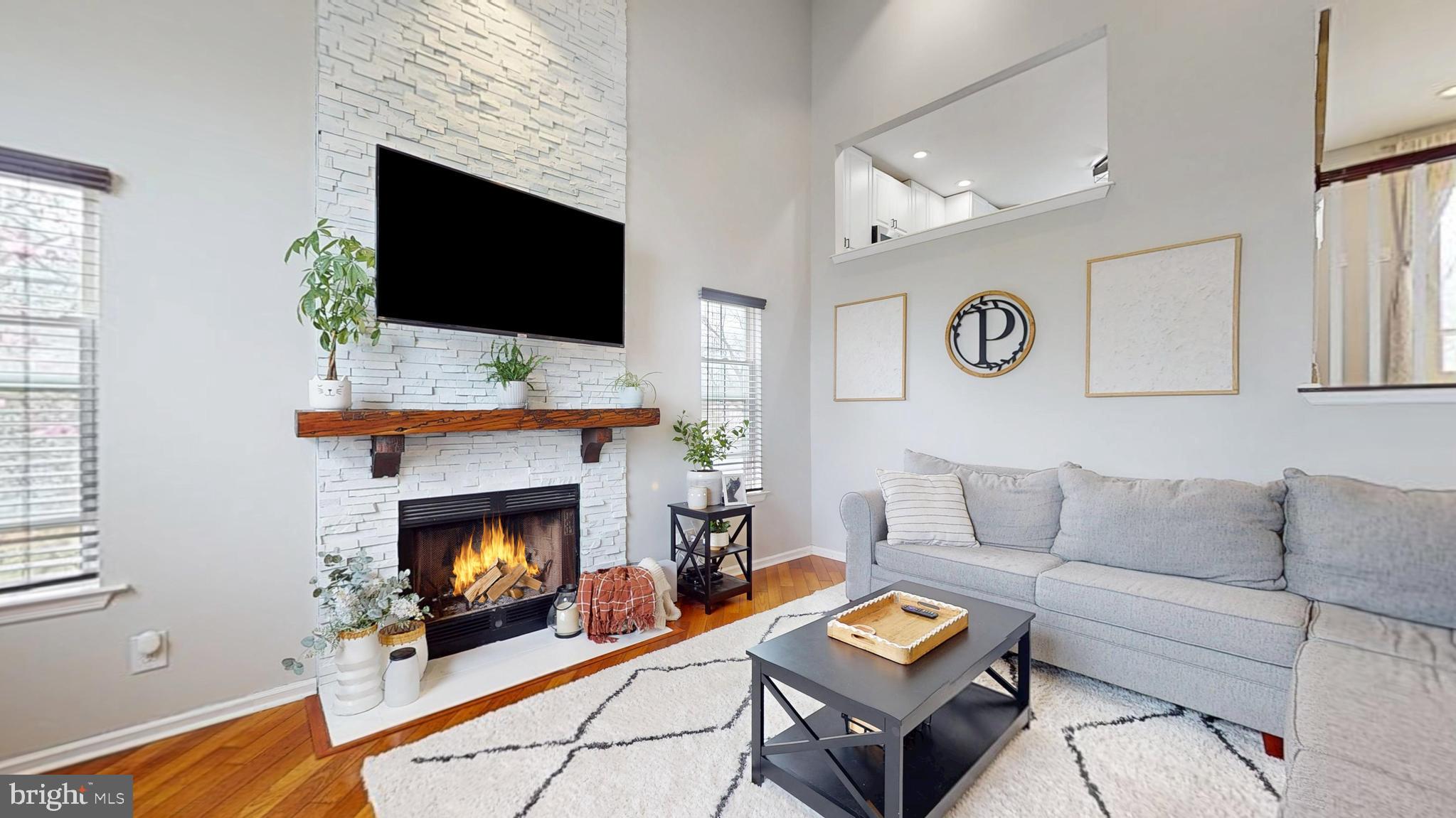 332 Copperfield Drive Williamstown, NJ 08094 - Photo 14 of 46 a living room with furniture a flat screen tv and a fireplace