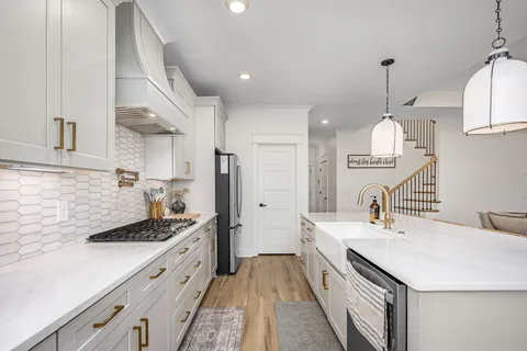 a kitchen with a sink stove and cabinets