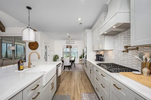 a kitchen with stainless steel appliances granite countertop a sink stove and refrigerator