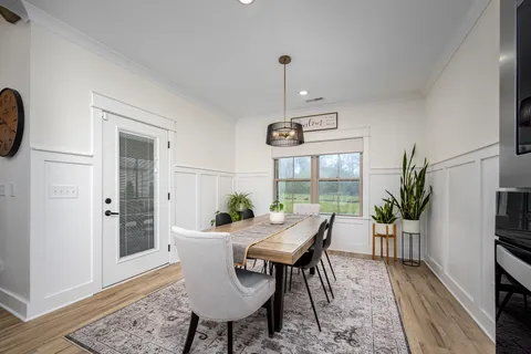 a view of a dining room with furniture window and wooden floor