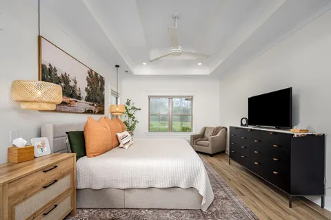 a bedroom with a bed and flat screen tv