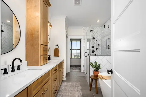 a spacious bathroom with a double vanity sink and a mirror