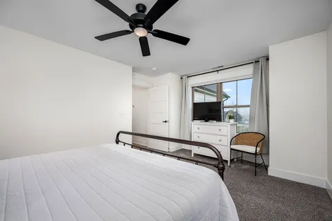 a bedroom with a bed and a chandelier