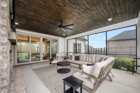 a balcony with furniture and a potted plant