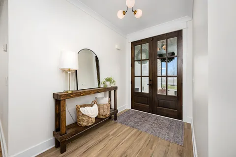 a view of an entryway with wooden floor