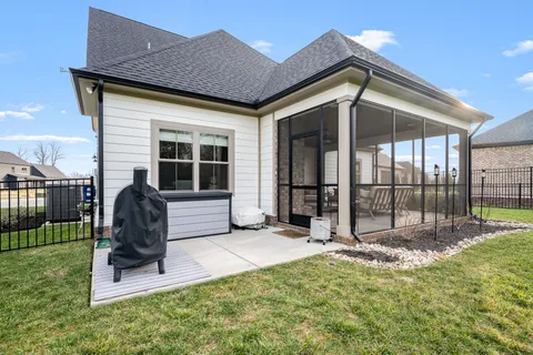 a backyard of a house with table and chairs