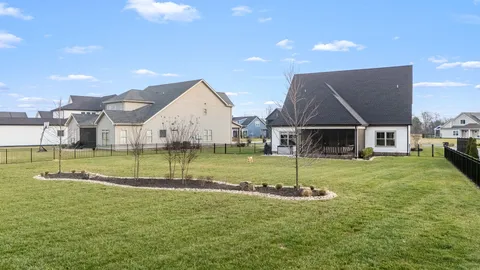 a view of house with a big yard and swimming pool
