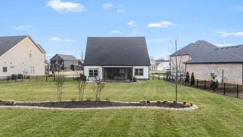 a view of a big house with a big yard and a fountain
