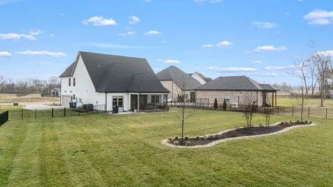 a backyard of a house with table and chairs
