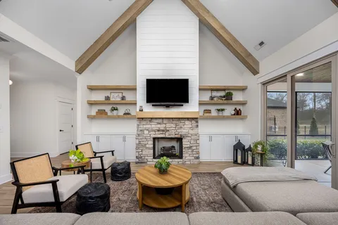 a living room with furniture a fireplace and a flat screen tv