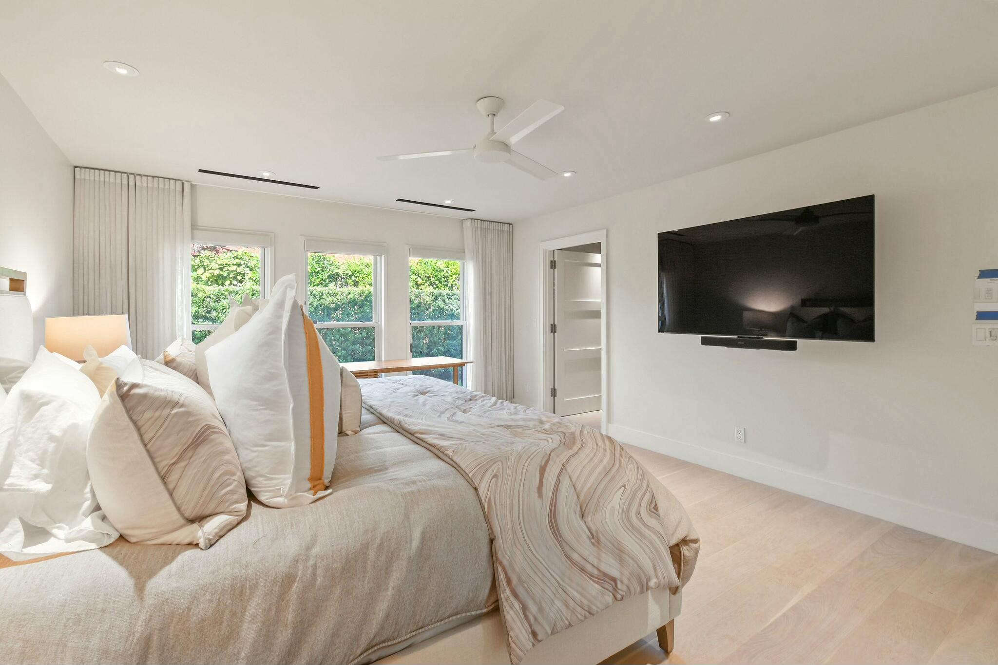 170 Beacon Lane Jupiter Inlet Colony, FL 33469 - Photo 12 of 46 a view of a bedroom with furniture and a flat screen tv