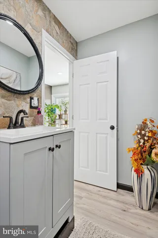 a view of two chair and a potted plant in a bathroom